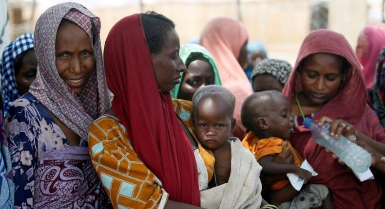 Women wait with their children under a shed for food rations at an internally displaced persons (IDP) camp on the outskirts of Maiduguri, northeast Nigeria June 6, 2017. 