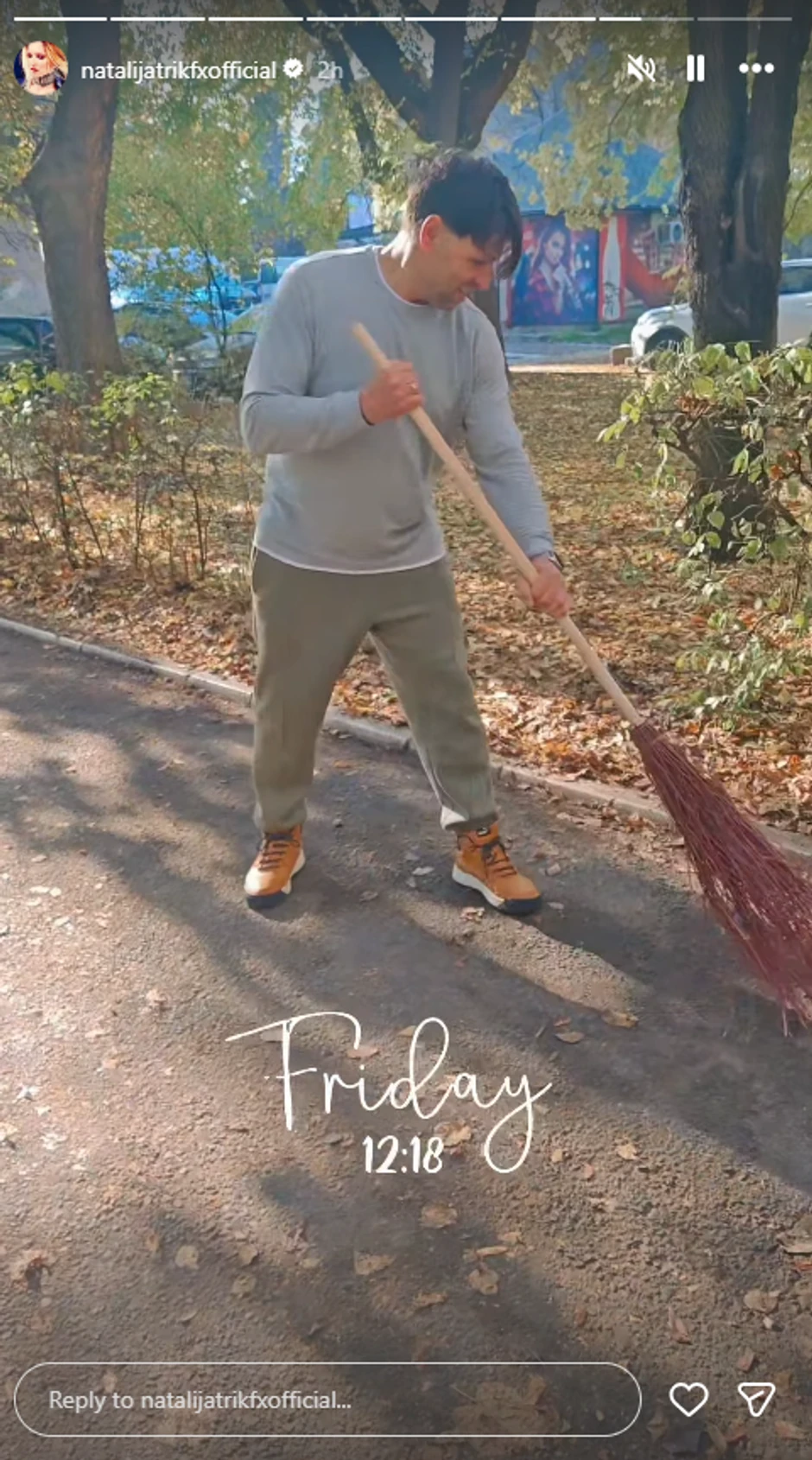 Sani čisti lišće ispred zgrade