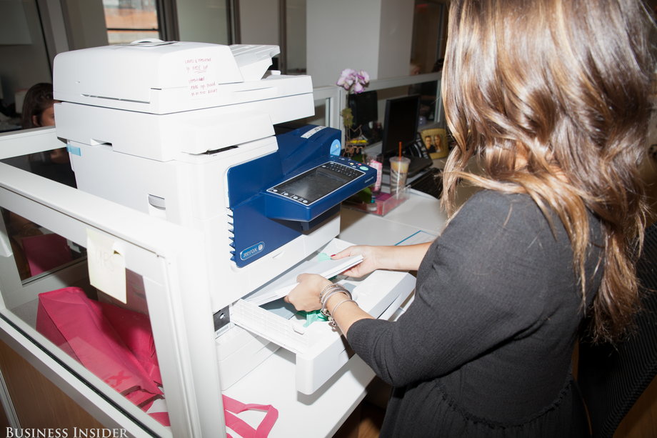 Here she is doing the most universal of all intern tasks: refilling the printer paper.