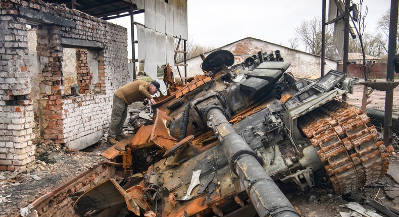 A man looks at Russian T-72 tank destroyed during Russia's invasion to Ukraine, Ivanivka village, Chernihiv area, Ukraine, on April 20, 2022.