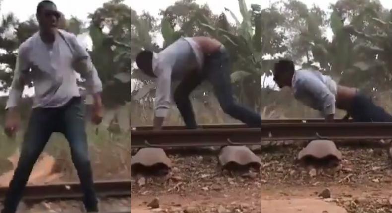 Daring man surprisingly survives after lying on a railway for a speeding train to pass over him (video)