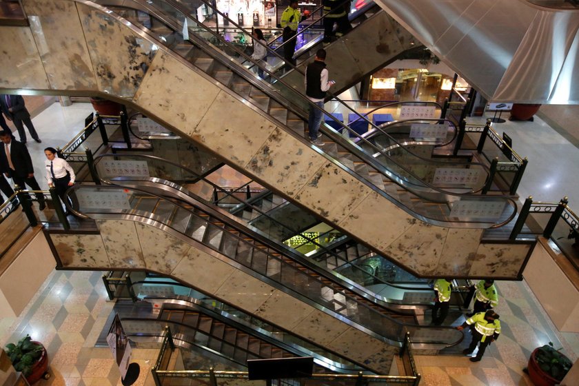 Police officers stand next to escalators inside the Andino shopping center after an explosive device