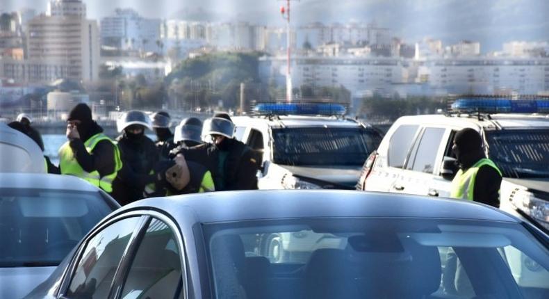 A suspected jihadist is escorted by Spanish Guardia Civil policemen after being arrested, in Spain's North African enclave of Ceuta, on January 13, 2017