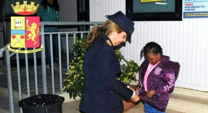 Police officer Maria Volpe takes care of Oumoh in Lampedusa on November 5