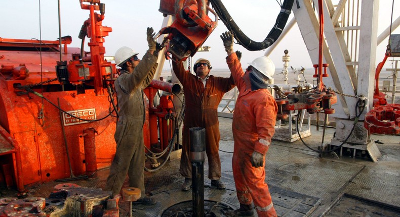 Kuwait Oil Company workers change pipes on a drilling rig on the northern border between Iraq and Kuwait.Joe Raedle/Getty Images