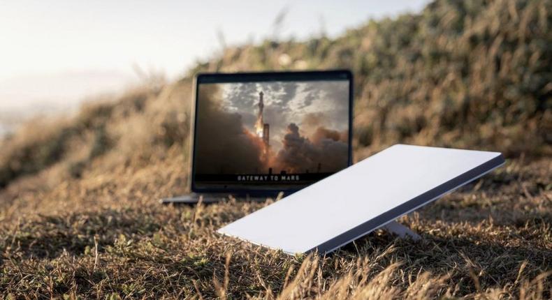 A marketing image of the new Starlink Mini next to a laptop.Starlink