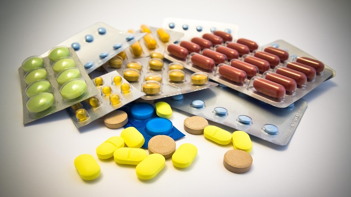 multi coloured pills on white background