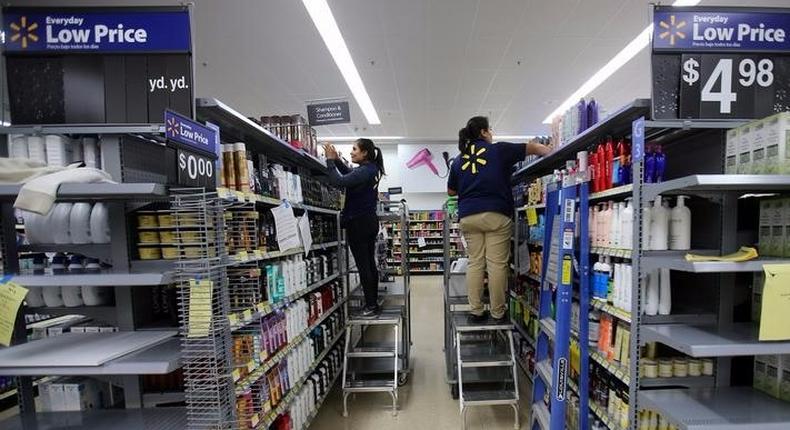 Workers stock shelves in a newly built Walmart Supercenter in Compton, California.
