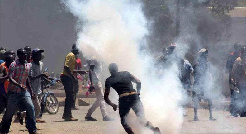 File image of protesters reacting to tear gas fired by police officers in a pst protest