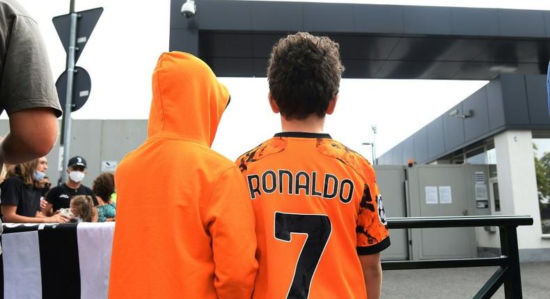 Juventuss fans wait for Cristiano Ronaldo outside the club's Continassa training centre in Turin on Friday Creator: -