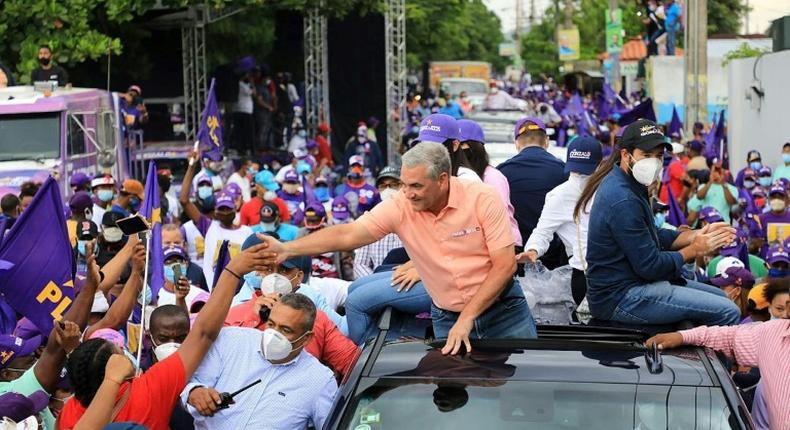 Ruling Dominican Liberation Party (PLD) candidate Gonzalo Castillo shakes hands with supporters in San Pedro de Macoris ahead vote