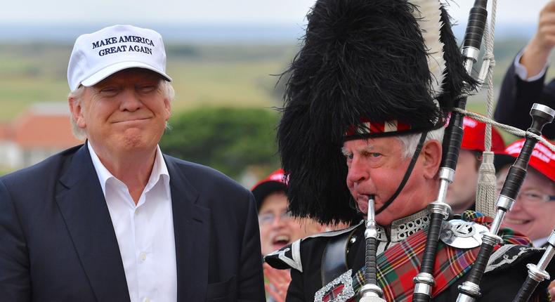 Scottish lawmakers have questioned how his golf courses were funded solely in cash, given the former president's debts.
