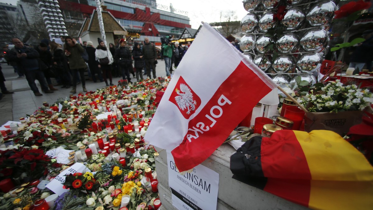 Flowers and candles are placed near the Christmas market at Breitscheid square in Berlin