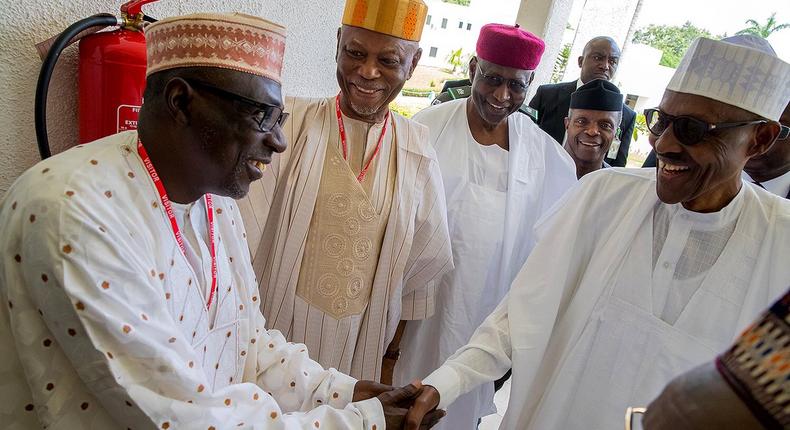 President Muhammadu Buhari shakes hands with Senator Ahmed Makarfi of the PDP during a political meeting