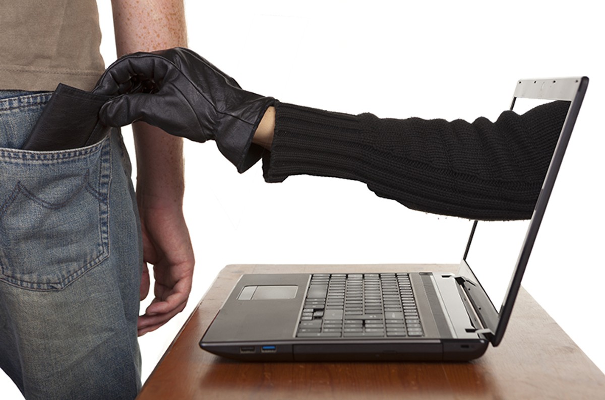 Internet,Theft,-,A,Gloved,Hand,Reaching,Through,A,Laptop