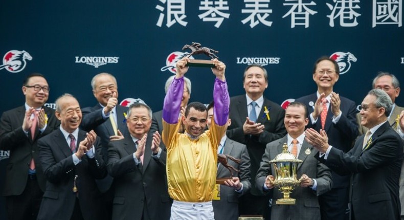 Hong Kong-based jockey Joao Moreira (C) is no stranger to the podium