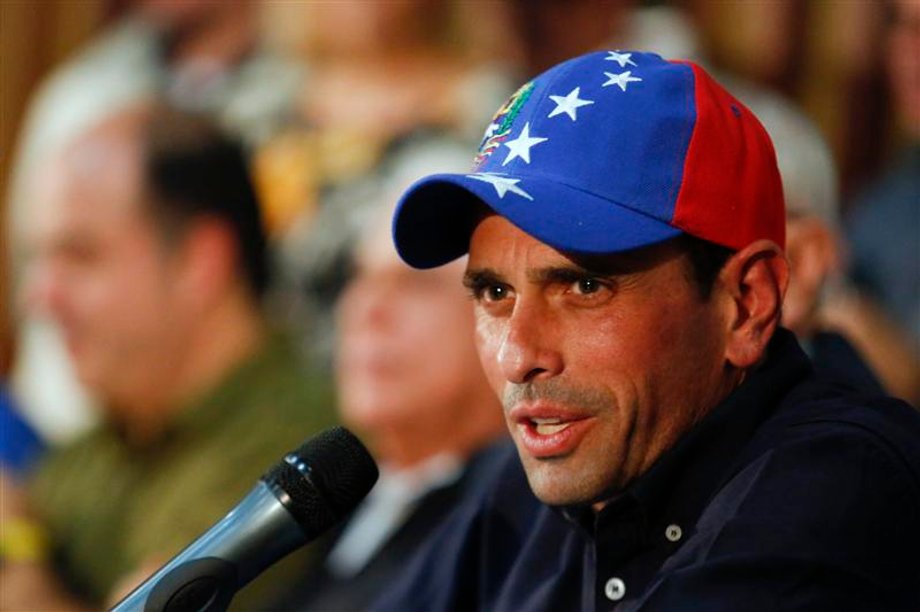 Venezuela's opposition leader and governor of Miranda state, Henrique Capriles, answers a question during a news conference in Caracas.