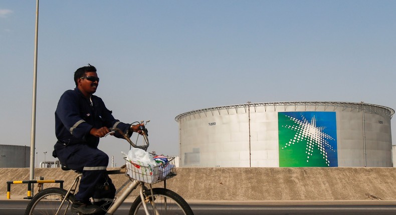 An employee rides a bicycle next to oil tanks at Saudi Aramco oil facility in Abqaiq, Saudi Arabia October 12, 2019. REUTERS/Maxim Shemetov