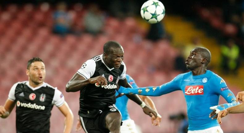 Besiktas' forward from Cameroon Vincent Aboubakar (C) scores in front of Napoli's defender from France Kalidou Koulibaly during the UEFA Champions League football match SSC Napoli vs Besiktas on October 19, 2016