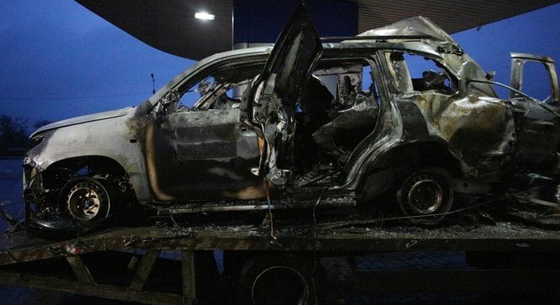 An OSCE mission patrol vehicle destroyed as a result of an explosion is towed not far from Lugansk, Ukraine on April 23, 2017