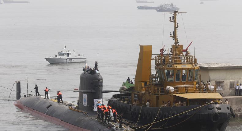 The Indian Navy's Scorpene submarine INS Kalvari escorted by tugs as it arrives at Mazagon Docks, a naval-vessel ship-building yard, in Mumbai, October 29, 2015.