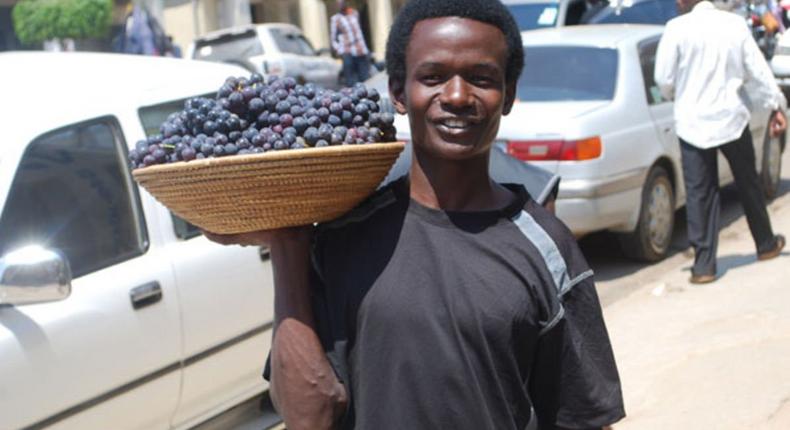 A man selling grapes in Mbarara town