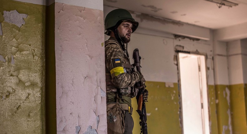 A Ukrainian soldier takes cover during heavy fighting at the front line in Severodonetsk, Luhansk region, Ukraine, Wednesday, June 8, 2022.