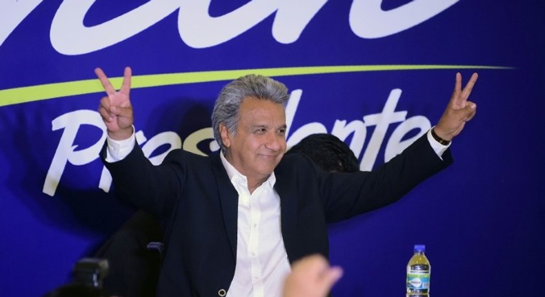 Lenin Moreno, the presidential candidate of the governing Alianza PAIS party, makes the V for victory sign to supporters at a hotel in Quito shortly before the results of the country's general elections are announced on February 19, 2017