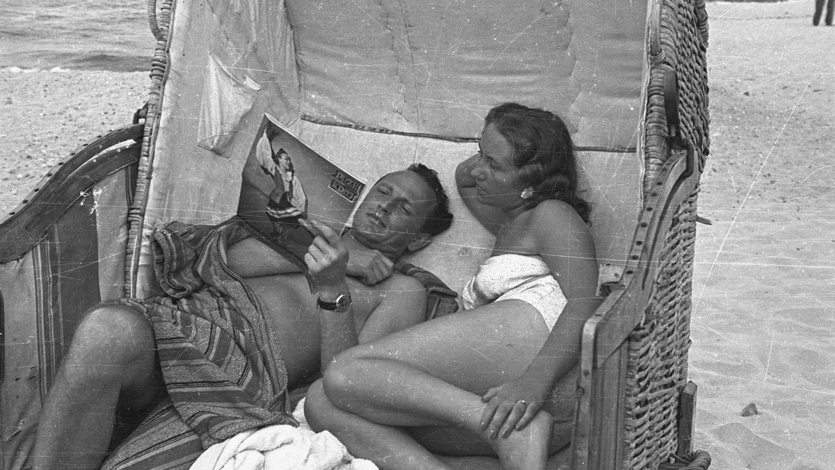 Międzyzdroje, 1948. Wczasowicze w koszu plażowym, mężczyzna czyta "Przekrój"