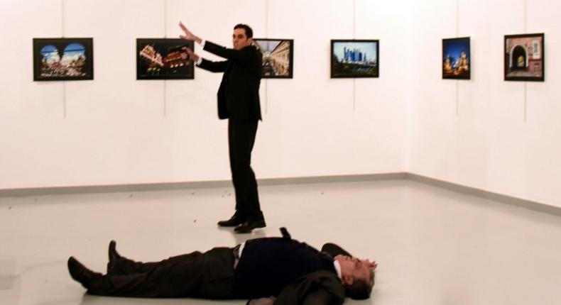 Andrei Karlov (front), the Russian ambassador to Ankara, lies on the floor next to his killer during an art exhibition in Ankara, on December 19, 2016