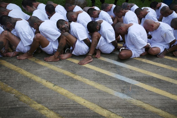 Mara Salvatrucha (MS-13) gang members wait to be escorted upon their arrival at the maximum-security