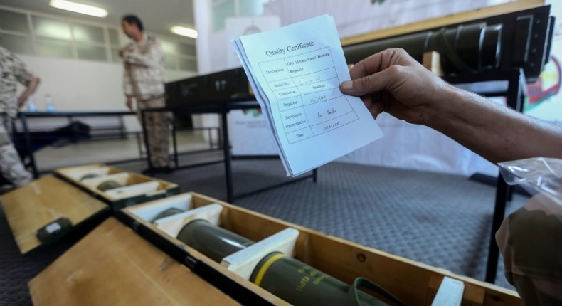 A picture taken in Tripoli in June 2019 shows fighters loyal to Libya's UN-recognised government displaying Chinese-made shells bearing the markings of the United Arab Emirates which were reportedly seized from the forces of strongman Khalifa Haftar