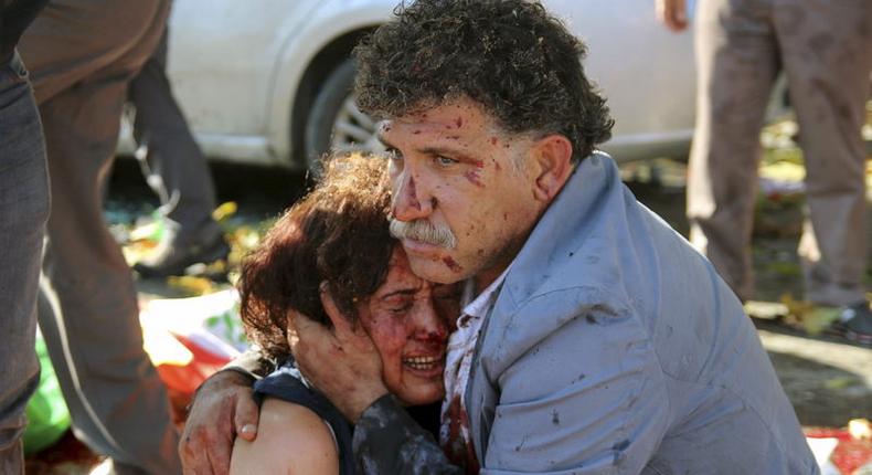 An injured man hugs an injured woman after an explosion during a peace march in Ankara, Turkey, October 10, 2015. REUTERS/Tumay Berkin