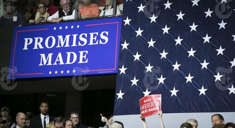 An audience member holds up a Make America Great Again sign in a crowd waiting to hear President Donald Trump speak at a campaign-style rally at the Kentucky Exposition Center in Louisville, March 20, 2017. Trump delivered a rollicking populist and nationalist appeal on Monday, promising to renegotiate trade agreements, clamp down on illegal immigration, keep terrorists out of the country – all in the service of putting America First. 