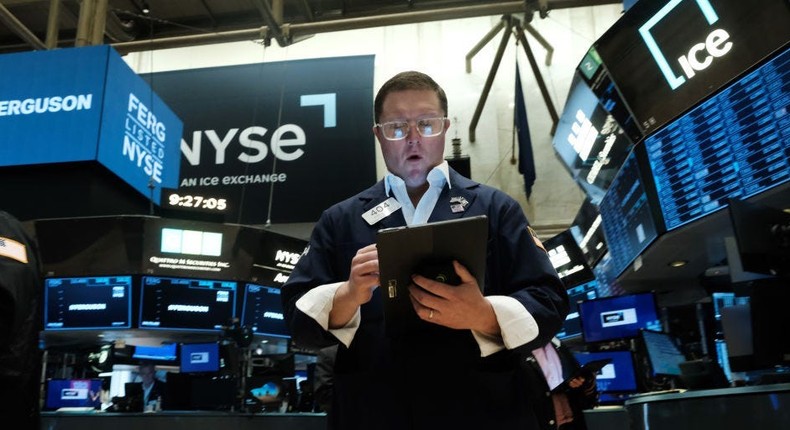 Traders work on the floor of the New York Stock Exchange (NYSE)