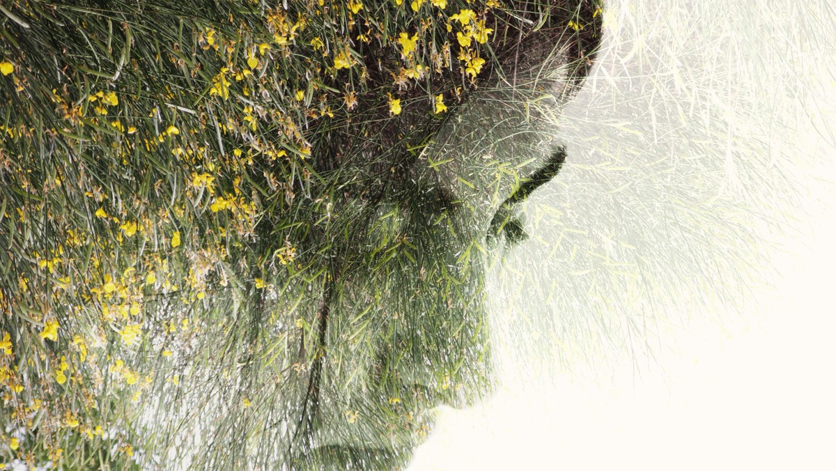 Double exposure of a young woman's face & flowers