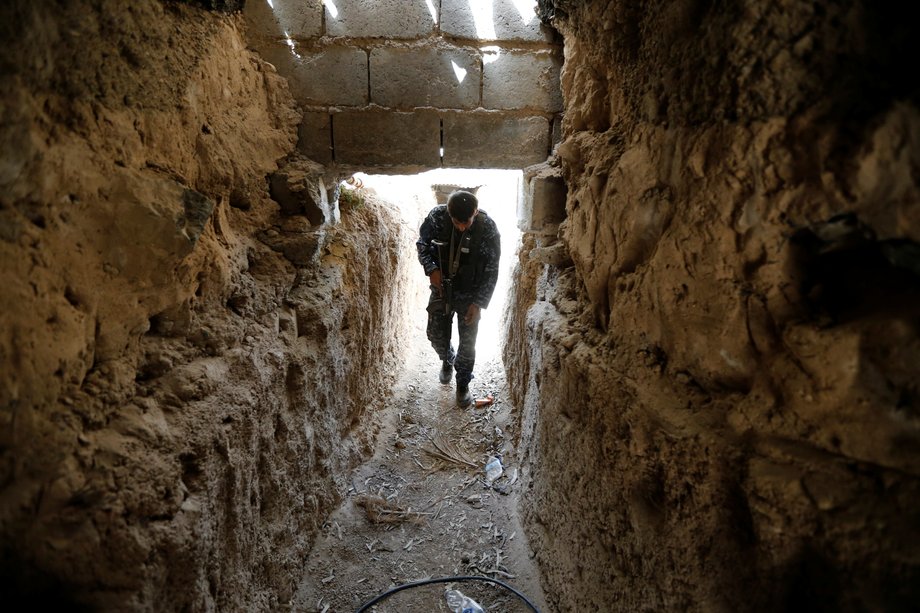 A fighter from the Iraqi Shi'ite Badr Organization holds his rifle in an underground tunnel built by Islamic State fighters on the outskirts of Fallujah, Iraq.