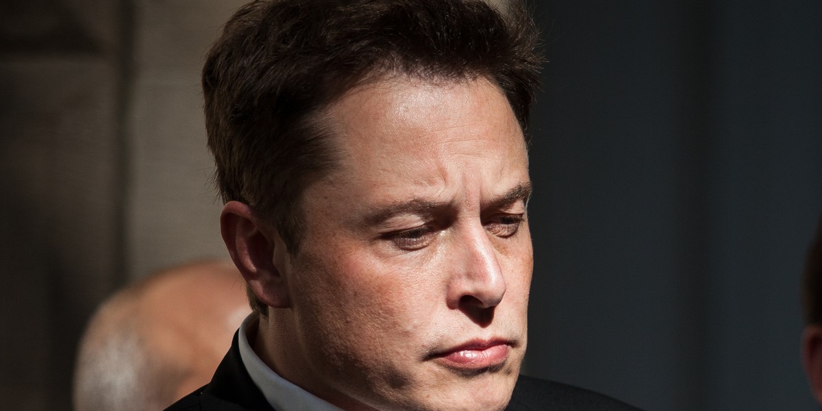 Elon Musk, CEO of Tesla Motors, listens as Governor Brian Sandoval of Nevada speaks during a press conference at the Nevada State Capitol, September 4, 2014 in Carson City, Nevada.