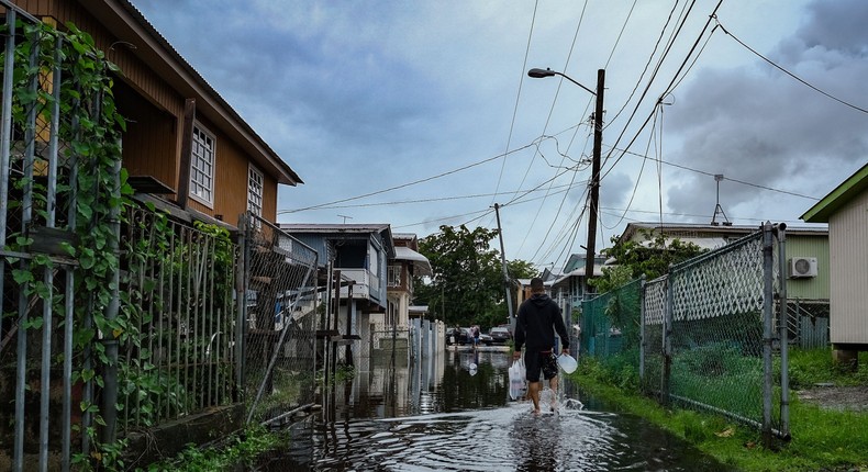 A man walks down a flooded street in the Juana Matos neighborhood of Catano, Puerto Rico, on September 19, 2022, following Hurricane Fiona.Photo by -/AFP via Getty Images