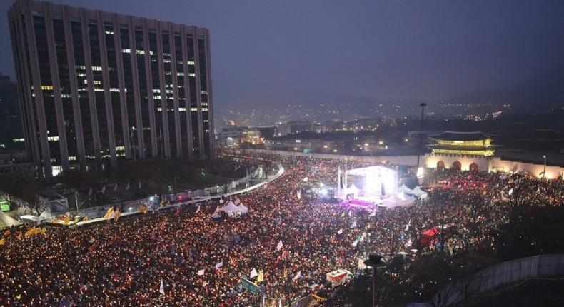 Protesters hold candles during a huge anti-government rally demanding the resignation of South Korea's President Park Geun-Hye in Seoul