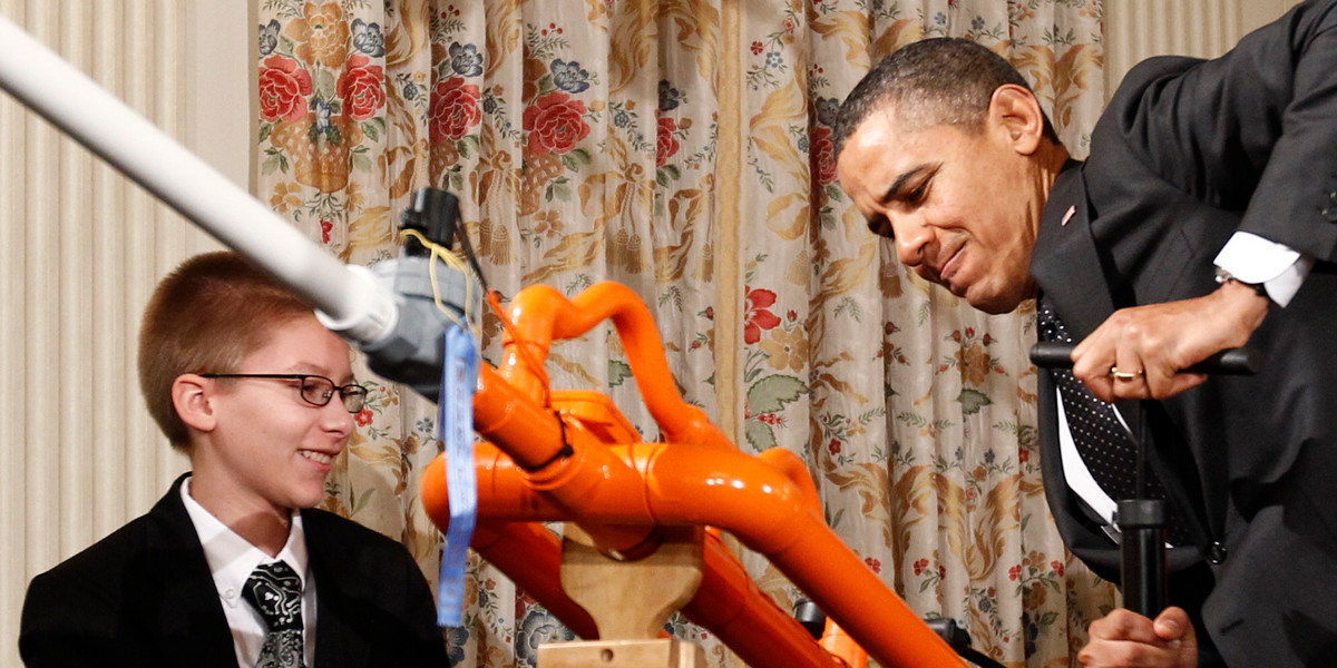 President Obama pumps air pressure into Extreme Marshmallow Cannon designed by Joey Hudy of Phoenix, before firing a marshmallow across the State Dining Room of the White House during the second White House Science Fair in Washington February 7, 2012.
