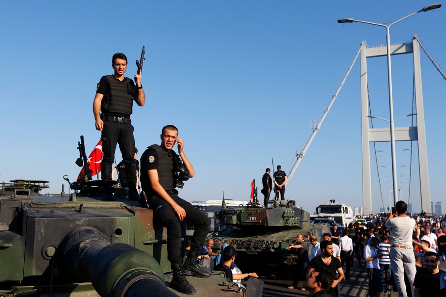 Policemen stand atop military armored vehicles after troops involved in the coup surrendered on the Bosphorus Bridge in Istanbul, Turkey, July 16, 2016.