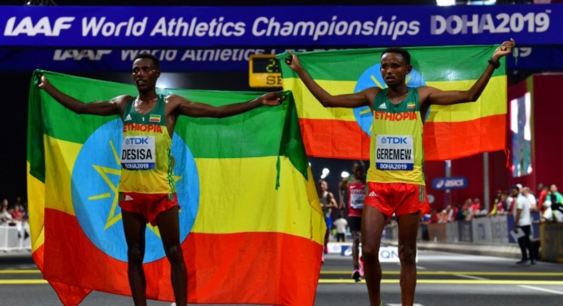 Migrant workers turned out in force to support runners from their native countries at the World Athletics Championships men's marathon in Doha, which saw Ethiopia's Lelisa Desisa (L) win gold