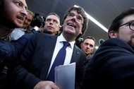 Sacked Catalan leader Carles Puigdemont departs after a news conference in Brussels