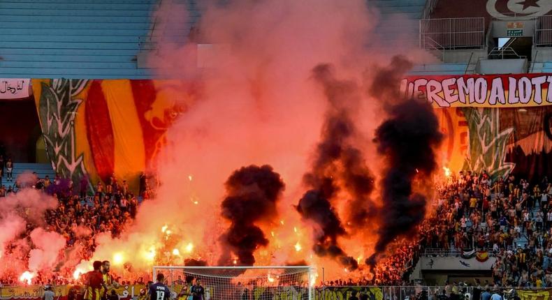 Esperance of Tunisia supporters light flares during the first leg of a CAF Champions League semi-final against Al Ahly of Egypt in Rades on Saturday. Creator: FETHI BELAID