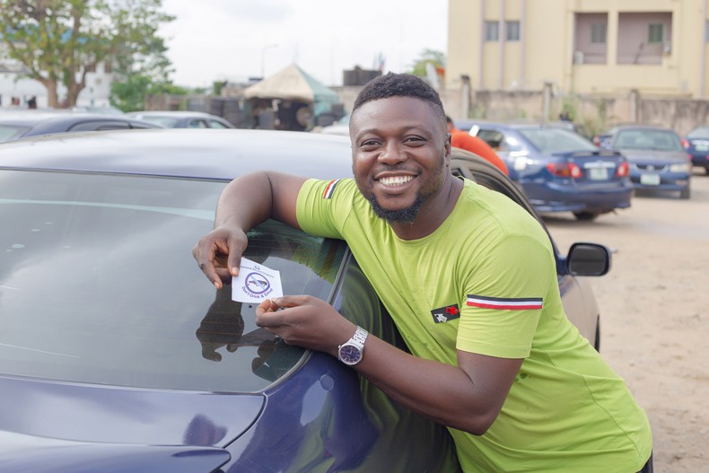 An excited driver with the Pernod Ricard Nigeria’s “Don’t Drink and Drive sticker at the International Airport Car Park, Ikeja