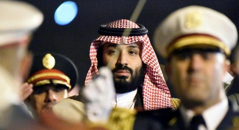 Saudi Crown Prince Mohammed bin Salman is seen behind a military band upon his arrival at Algiers International Airport, southeast of the capital Algiers on December 2, 2018