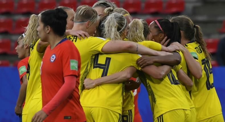 Sweden scored two late goals to beat Chile after a lengthy delay in their game due to a storm