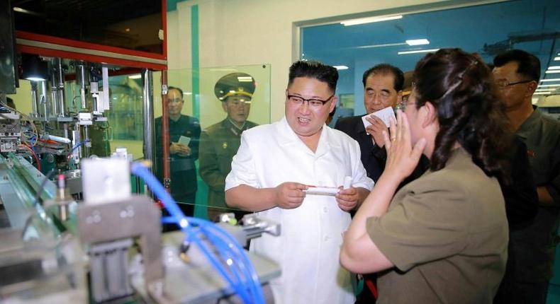 This undated picture released from North Korea's official Korean Central News Agency (KCNA) on June 20, 2017 shows North Korean leader Kim Jong-Un (C) visiting a newly-built dental sanitary goods factory at an undisclosed location in North Korea