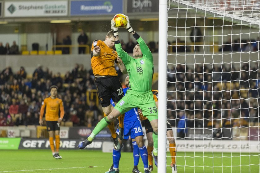 Tomasz Kuszczak of Birmingham City catches a cross just as Jn Da i B varsson of Wolverhampton Wand